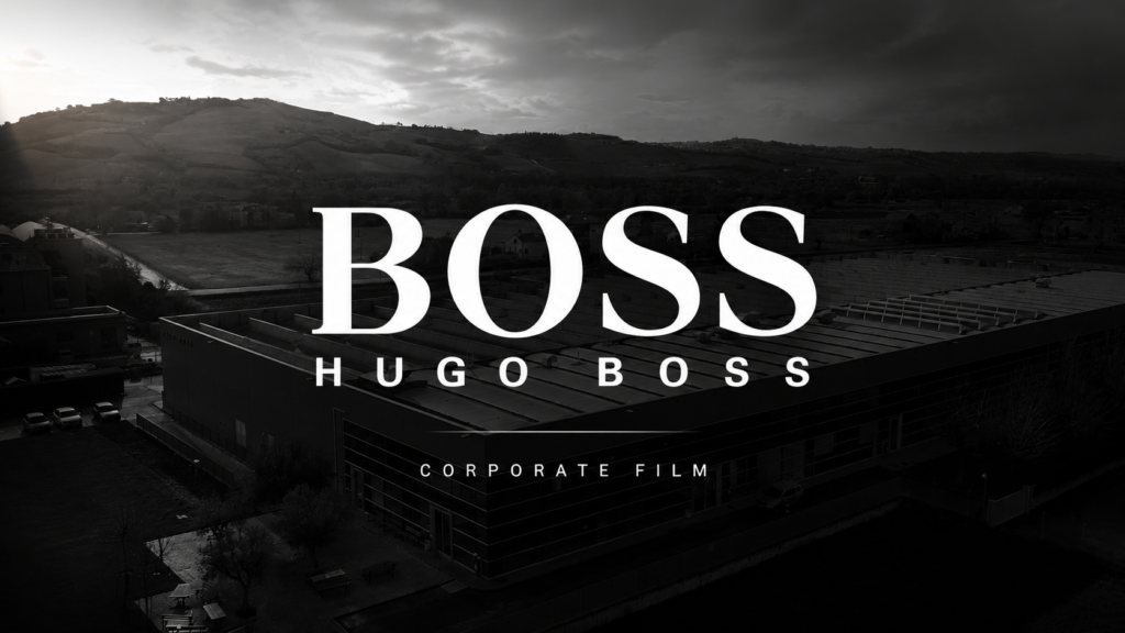 Copertina del corporate film realizzato per HUGO BOSS, con vista aerea della sede aziendale e grafica minimal in bianco e nero. Video corporate dedicato al settore moda e luxury.